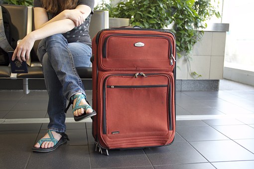 woman sitting near luggage 